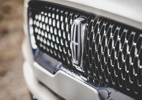 The grille of the 2024 Lincoln Aviator® Reserve model with an eye-catching repeated field of Lincoln Star logo shapes | Krenzen Lincoln in Duluth MN