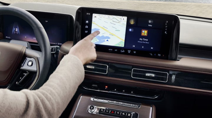 A person is tapping the center display touchscreen of a 2026 Lincoln Aviator® SUV. | Krenzen Lincoln in Duluth MN