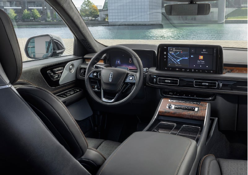 The interior of the 2026 Lincoln Aviator® SUV is shown parked with a view of a harbor through the windshield. | Krenzen Lincoln in Duluth MN