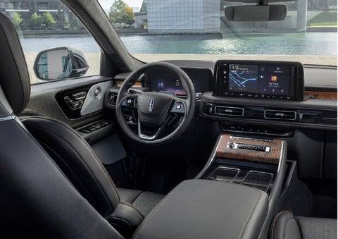 The interior of the 2026 Lincoln Aviator® SUV is shown parked with a view of a harbor through the windshield. | Krenzen Lincoln in Duluth MN