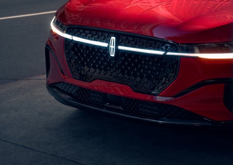 The available front LED light bar and center Lincoln Star logo glow at dusk. | Krenzen Lincoln in Duluth MN