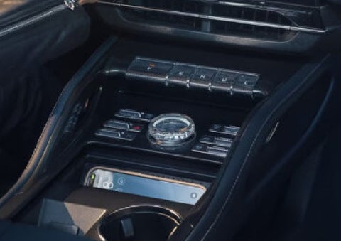 A smartphone is shown charging in the wireless charging pad. | Krenzen Lincoln in Duluth MN