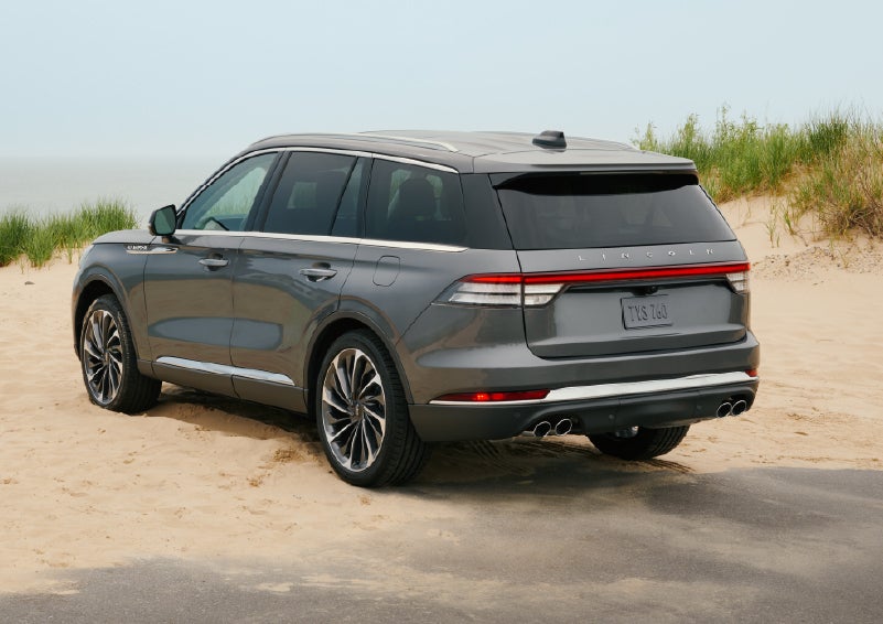 A 2027 Lincoln Aviator® SUV is parked next to sand dunes. | Krenzen Lincoln in Duluth MN