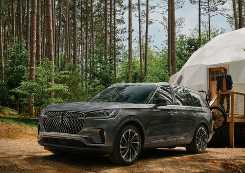 A 2027 Lincoln Aviator® is parked next to a high end glamping site. | Krenzen Lincoln in Duluth MN