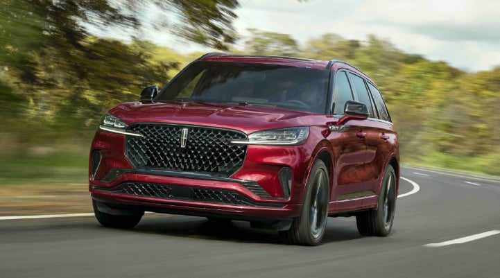 A 2027 Lincoln Aviator® SUV is being driven on a country road | Krenzen Lincoln in Duluth MN