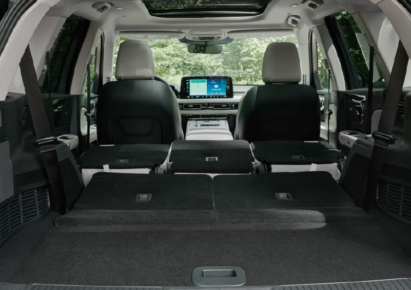 A rear to front view of the interior of a 2027 Lincoln Aviator® Black Label™ SUV shows the third and second rows folded flat | Krenzen Lincoln in Duluth MN