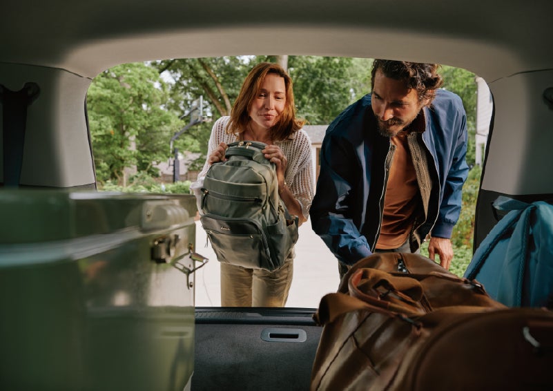 A couple loads luggage into the rear of a 2027 Lincoln Aviator® Black Label™ SUV..e 202 | Krenzen Lincoln in Duluth MN