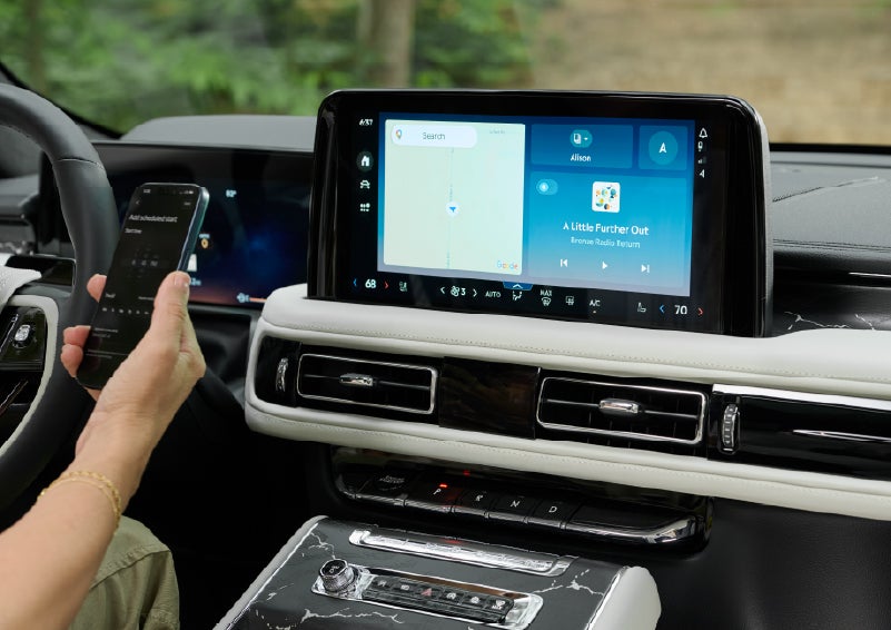 A person pairs thier phone with the center touchscreen of a 2027 Lincoln Aviator® Black Label™ SUV | Krenzen Lincoln in Duluth MN